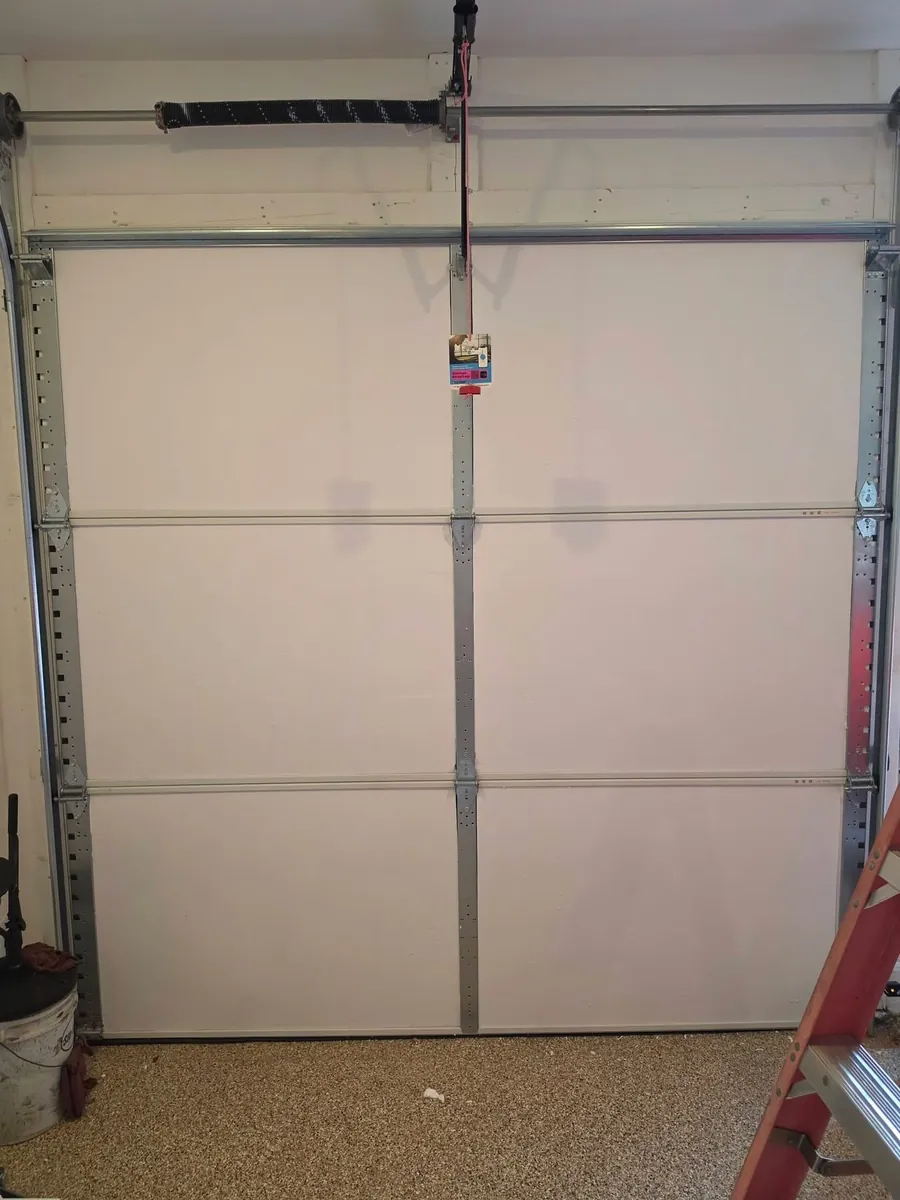 Interior view of insulated sectional garage door panels and their mounting hardware